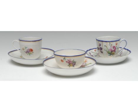 A Chelsea-Derby fluted coffee cup and saucer, painted in polychrome enamels with scattered country flowers in bloom, alternat