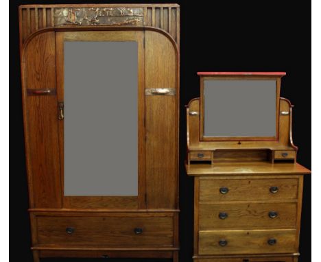 An Arts &amp; Crafts two piece bedroom suite by Harris Lebus, pat.no.8896/1904, comprising wardrobe and a dressing table, dee