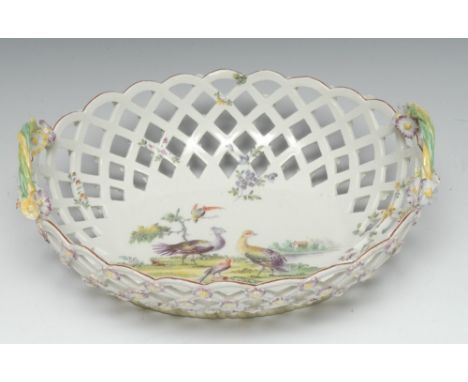 An early Derby basket, the centre painted in polychrome with exotic fowl by a riverside, the pierced sides picked out with sc