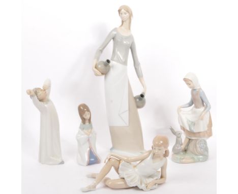 A collection of five vintage 20th century Nao Spanish porcelain figurines by Lladro. Lotto include; yawning boy, girl with ra