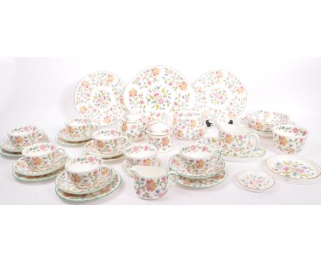 A vintage 20th century Minton bone china tea service in the Haddon Hall pattern. To include a teapot, serving bowls, dishes, 