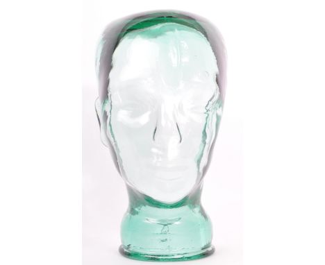 A vintage 20th century clear green glass milliners mannequin pressed glass head having moulded features and dappled effect to