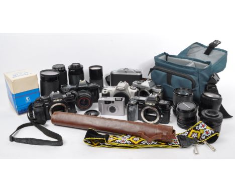 A collection of retro vintage 20th century cameras, lenses &amp; camera equipment. The lot to include Yashica, Canon, Olympus