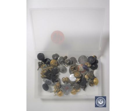 A box containing military and service buttons and badges, miner's lamp token, military tag etc
