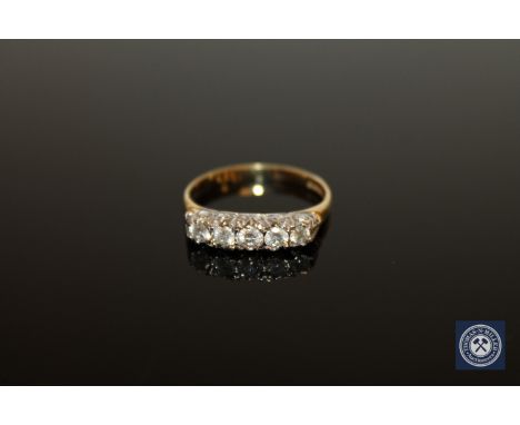 An 18ct gold five stone diamond ring, size P1/2