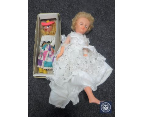 A box of mid 20th century doll in white dress and a boxed Pelham puppet 