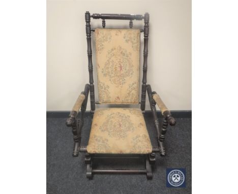 A mahogany framed tapestry upholstered American style rocking chair