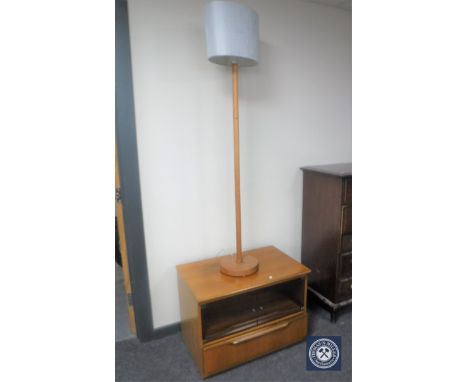 A teak glass door entertainment stand together with a teak standard lamp with shade