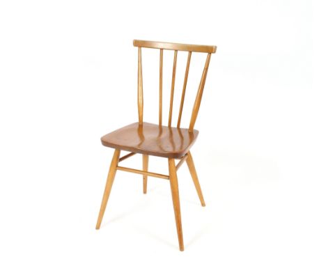 A set of four light Ercol stick back dining chairs