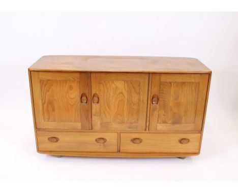 A light Ercol sideboard, enclosed by three doors with two drawers to base, 129cm wide x 46.5cm deep