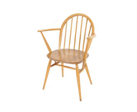 A set of four light Ercol stick back elbow chairs