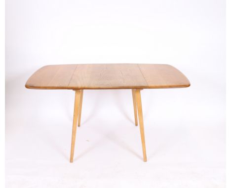 A light Ercol drop leaf extending dining table, 133cm wide x 74cm deep