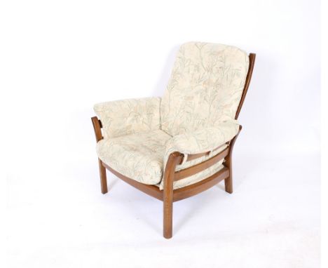 En Ercol armchair, upholstered en suite to the previous lot