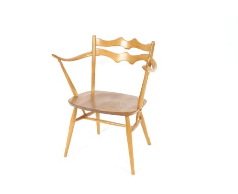 A pair of blonde Ercol elbow chairs, with shaped backs