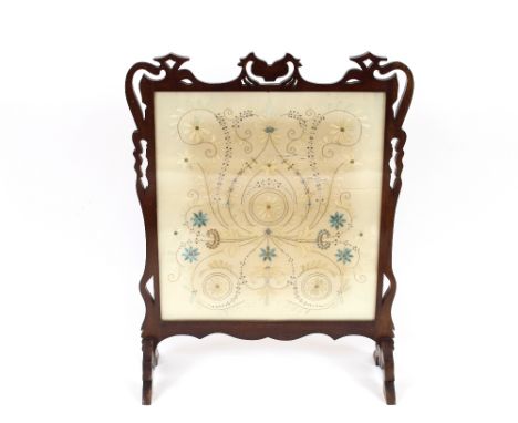 An Art Nouveau design mahogany framed fire screen, with floral embroidered silk work panel, 68cm wide