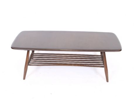 A dark Ercol oblong coffee table, with rounded tapering supports united by an under-tier, 104cm wide