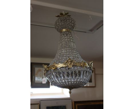 A large brass chandelier, hung with prism drops, 66cm