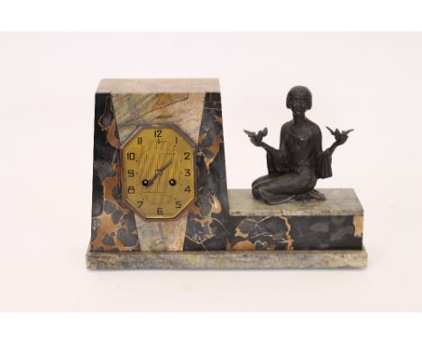 An Art Deco mixed marble mantel clock, decorated with spelter female figure holding two doves, signed Sega, (AF), 16cm