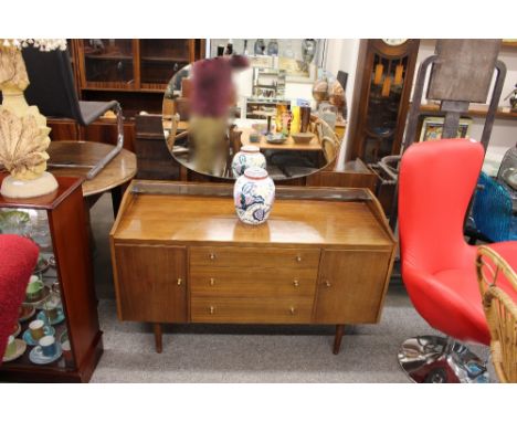 A Wrighton "unit furniture" dressing table, with mirrored back above glass shelf, three central drawers flanked by cupboards 