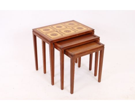 A nest of three 1960's Danish teak occasional tables, by Mobelfabriken, the largest with a tile inset top, 52cm wide