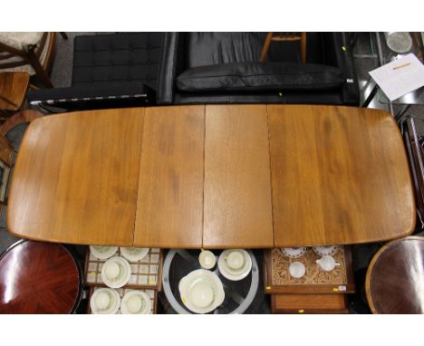 A light Ercol extending dining table, with two extra leaves, 220cm long x 82cm deep