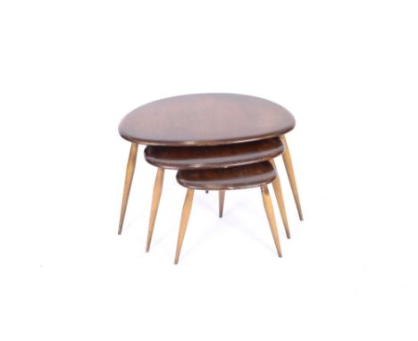 A nest of three dark Ercol pebble shaped coffee tables