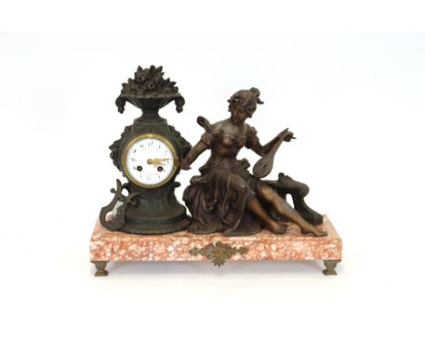 A French mantel clock, decorated with spelter figure of a female and raised on rouge marble base, 40cm high in extremes 
