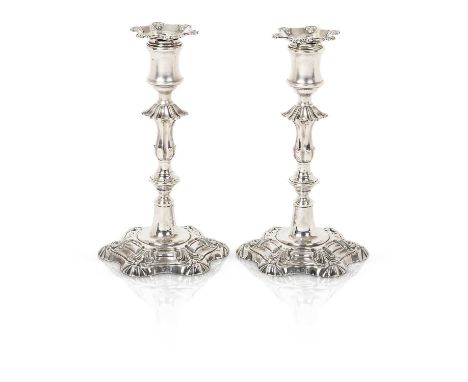 each in the George II style, with hexafoil base with shell corners, the knopped stems terminate in spool-shaped sockets with 