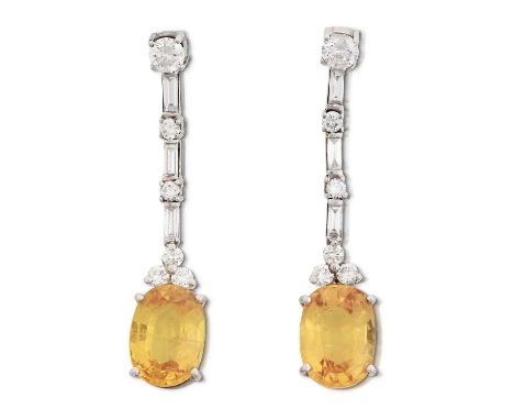 round brilliant cut and baguette cut diamonds alternate to a trio of diamonds surmounting an oval mixed cut yellow sapphire, 