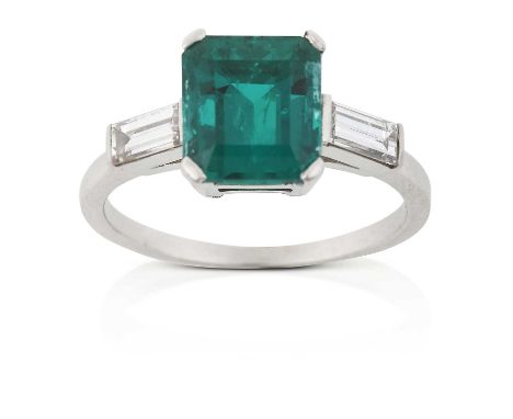 the emerald-cut emerald in a white claw setting, to baguette cut diamond set shoulders, on a plain polished shank, total esti