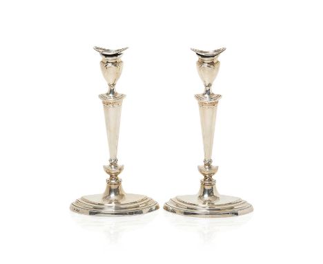 each with stepped oval base and tapering stem, with conforming sockets, the nozzle fixed, filled30.5cm high (2) Fully marked 