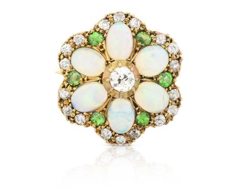 modelled as a stylised floral motif, the central old cut diamond in a yellow collet setting, within a border of oval cabochon