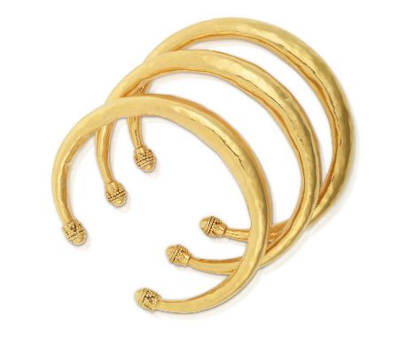each of yellow tapered planished design, terminating to beadwork capsinner measurements 5.6cm by 4.5cmThe bangles are in fair