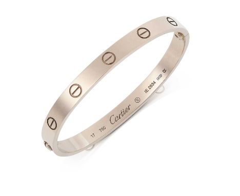 the white polished bangle with screwhead motifsinner measurements 5.6cm by 4.7cmThe bangle is accompanied by the original pur