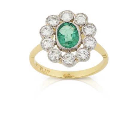 the oval cut emerald within a border of round brilliant cut diamonds, in white millegrain settings, to a yellow tapered shoul