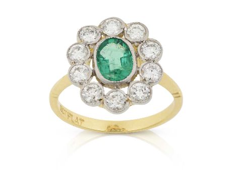 the oval cut emerald within a border of round brilliant cut diamonds, in white millegrain settings, to a yellow tapered shoul