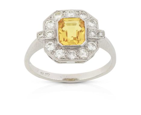 the emerald-cut yellow sapphire within a border of round brilliant cut diamonds, in white millegrain settings, to a tapered s