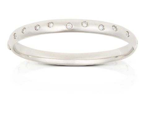 nine round brilliant cut diamonds inset within a white plain polished bangle, to a hinged back, total estimated diamond weigh
