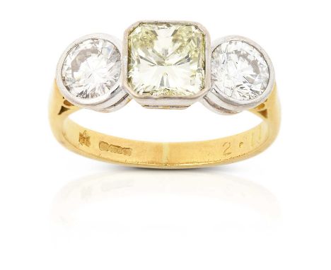 the octagonal cut diamond flanked by round brilliant cut diamonds, in white rubbed over settings, to a yellow tapered shoulde