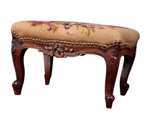 A FRENCH CARVED OAK FOOTSTOOL with floral tapestry seat, on leaf capped cabriole legs, 23cm high x 40cm x 32cm 