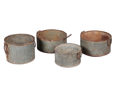 A GROUP OF FOUR GALVANISED JARDINIERES all with hooped handles, the tallest is 23cm high, the shortest is 17cm high (4)Proven