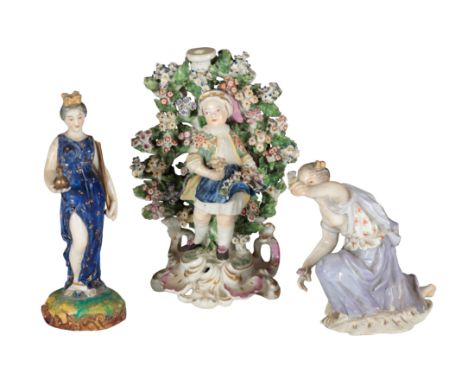 AN 18TH CENTURY DUESBURY &amp; CO DERBY PORCELAIN CANDLESTICK modelled with a boy wearing blue apron, standing amongst bocage