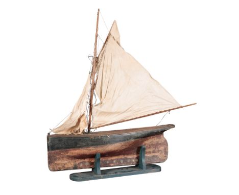 A VINTAGE MODEL GAFF RIGGED CUTTER late 19th or early 20th century, with stained wood hull and metal mounted keel, the sails 