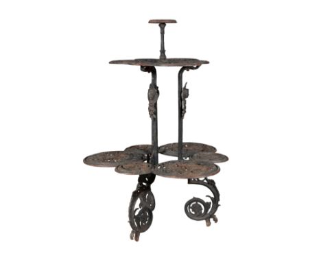 A VICTORIAN CAST IRON JARDINIERE STAND 19th century, with three pierced and foliate cast tiers, on scrolling legs, 113cm high
