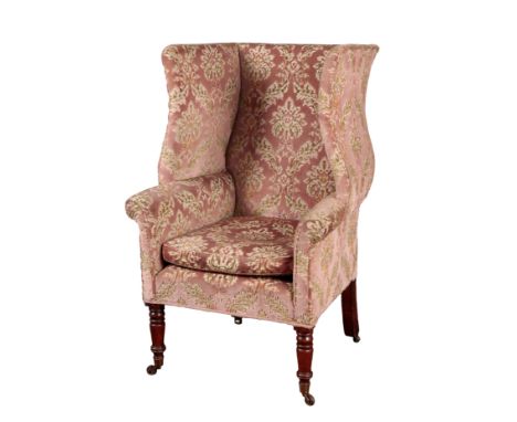 A VICTORIAN WING ARMCHAIR 19th century, with floral pattern cut velvet covers, the shaped wings above outswept arms, over a s