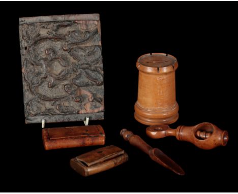 A COLLECTION OF TREEN including two snuff boxes, a coin box, 9.5cm high, a nutcracker, a scoop, and a carved panel fragment, 