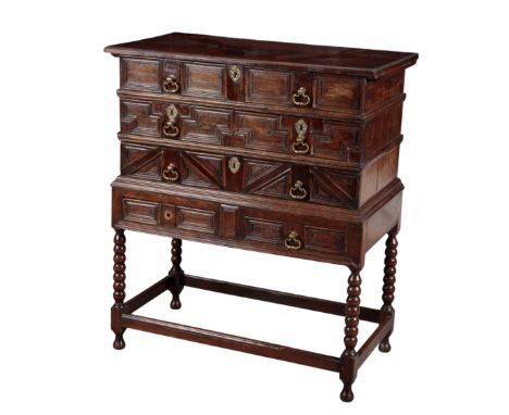 A 17TH CENTURY OAK CHEST ON STAND with later elements and additions, the stand is associated, the top is hinged and opens to 