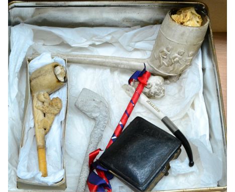 A Jumbo Clay Pipe with Football Scene, together with other clay pipes, including a Kitchener pipe and a lion pipe