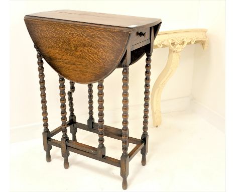 Small 20th century oak gateleg occasional table, with oval top raised on bobbin turned supports, (W74cm) together with a whit