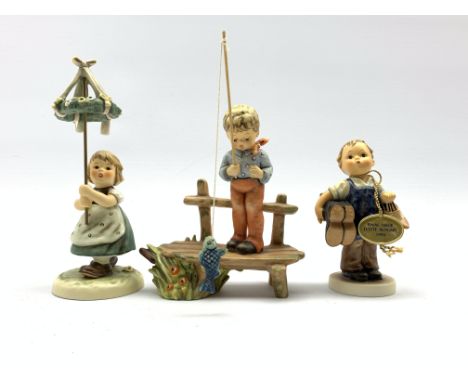 Three Hummel Goebel figures 'The Angler', 'Boots' and 'May Dance', all boxed Condition Report & Further Details Click here fo